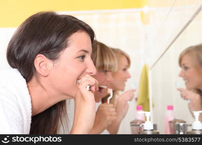 Women brushing their teeth