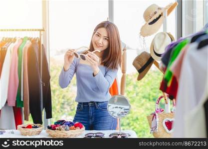 women buying sunglasses enjoy happy to select eyewear in fashion shop for coming summer season.
