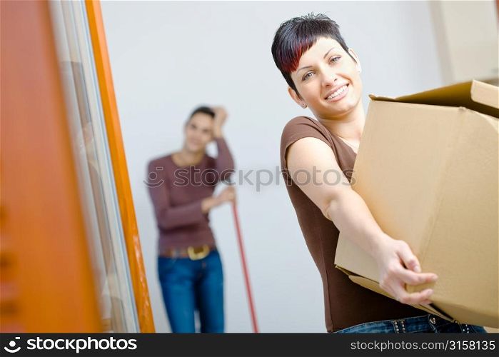 Women carrying a box