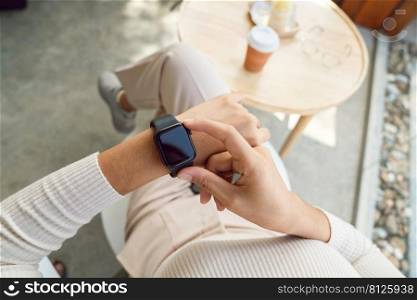 women checking smartwatch on her hand