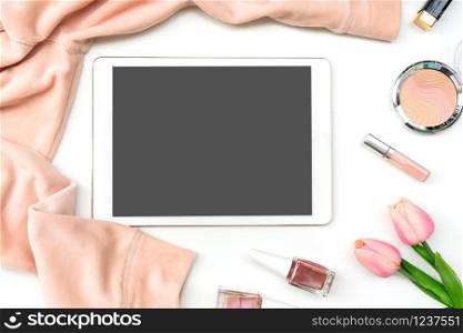 Women cloth, nail polish ,cosmetic and tablet on white background, beauty concept, top view, copy space.