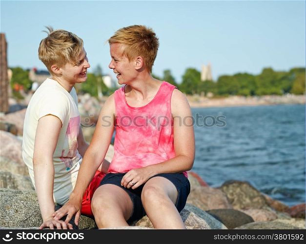 Women couple spend time together at the beach in the afternoon
