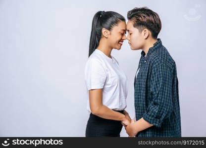 Women couples stand and fragrant cheek.