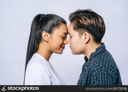 Women couples stand and fragrant cheek.