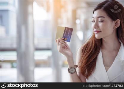 Women crazy shopaholic holding shopping bags , money ,credit card person at shopping malls.Fashionable Woman love online website with sales tag on black friday. E-commerce digital marketing lifestyle