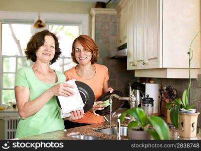 Women doing dishes in kitchen