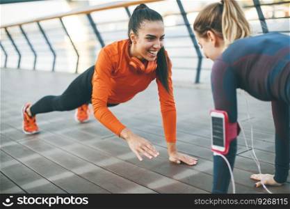 Women doing plank on riverside after running
