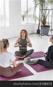 women doing yoga indoors