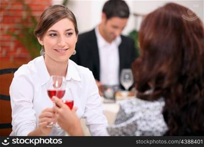 women drinking wine in a restaurant