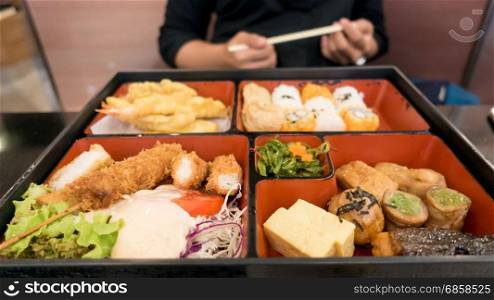 women eating bento box set in japanese restaurant