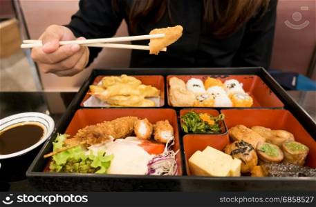 women eating bento box set in japanese restaurant