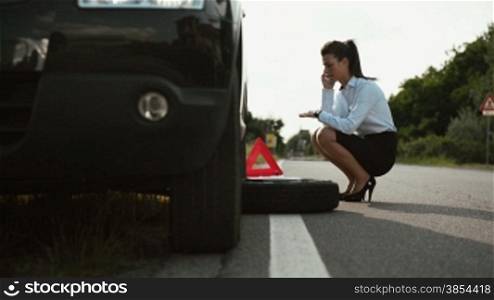 Women, emergency and driving problems, frustrated girl with flat car tire calling tow truck
