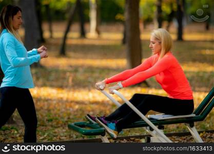 Women Exercising Outdoors in a Public Park.