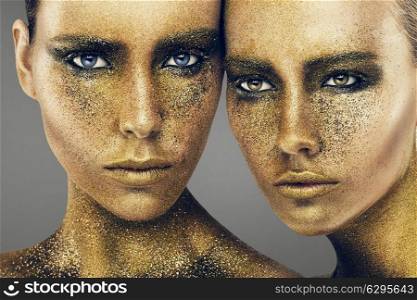 women faces in gold glitters