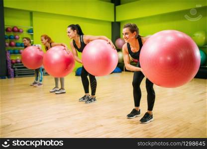 Women group with big balls doing exercise, fitness workout. Female sport teamwork in gym. Fit class, aerobic. Women group with big balls doing exercise, fitness