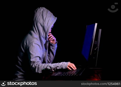 Women hacker breaks into government data servers and Infects Their System with a Virus at his hideout place has dark atmosphere, Lady hooded using laptop on binary code background