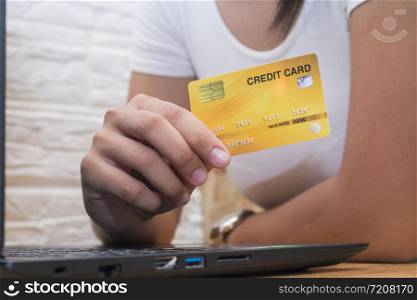 Women hand holding credit card in cafe, Close up