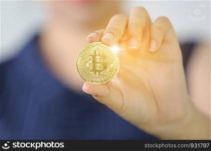 women hand holding gold bit coin