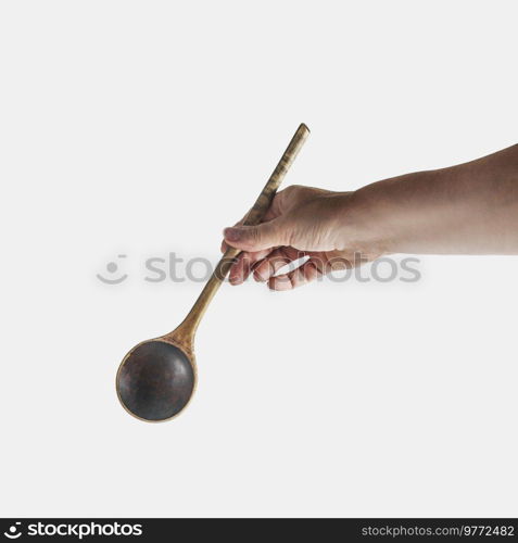 Women hand holding wooden spoon at white background