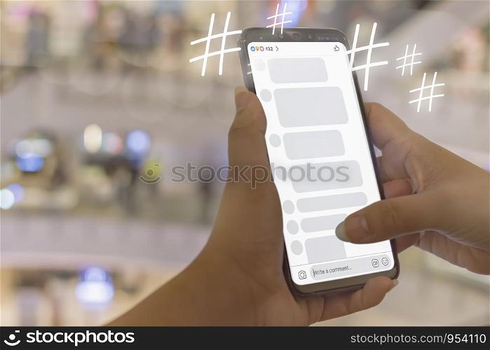 Women hand is playing Social Media idea a word or phrase preceded by a hash or pound sign (#) and used to identify messages on a specific topic.Soft focus