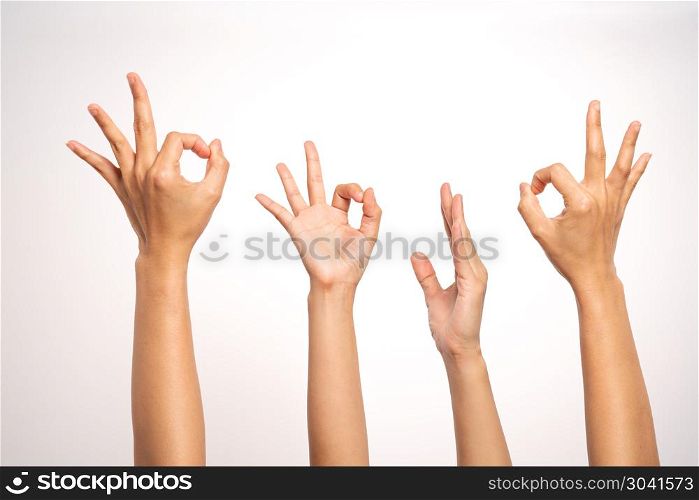 women hand OK sign and raise hand up gesturing on white backgrou. women hand OK sign and raise hand up gesturing on white background in four action