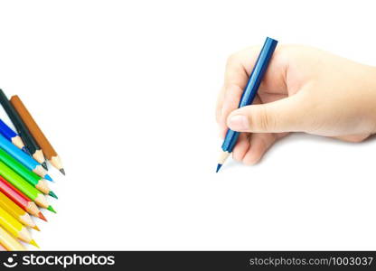 Women hand with pencil by hand on white paper at white background, lady is holding a crayon in his hands at paper and crayons for drawing