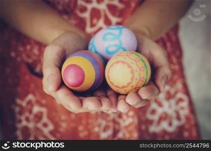 Women hands holding easter eggs painted color on hand