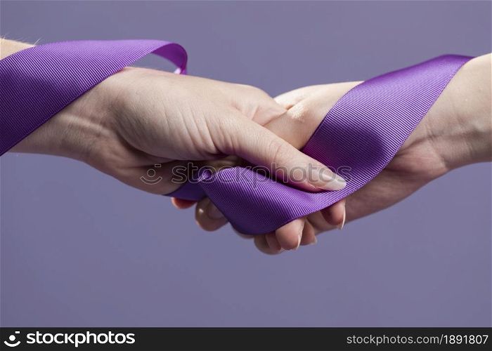women hands holding purple satin ribbon. Resolution and high quality beautiful photo. women hands holding purple satin ribbon. High quality and resolution beautiful photo concept