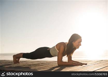 Women having a time doing pilates on the beach