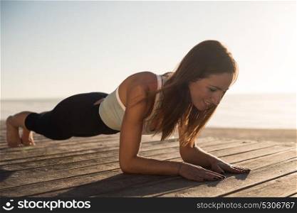 Women having a time doing pilates on the beach