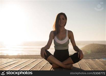 Women having a time meditating on the beach
