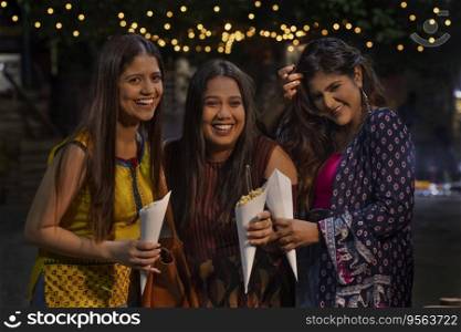 women having fun and eating Jhalmuri on street