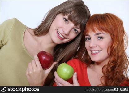 Women holding apples