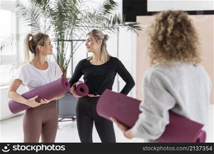 women holding yoga mats