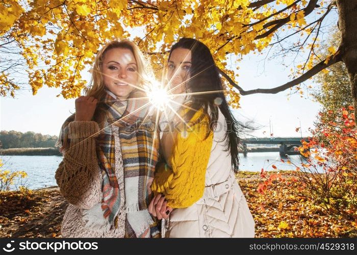 Women in autumn park. Two cheerful women in autumn park at sunny day
