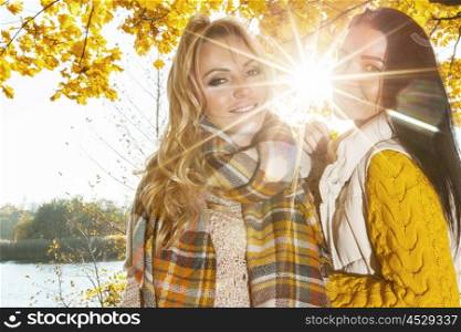 Women in autumn park. Two cheerful women in autumn park at sunny day