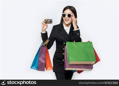 Women in black wear glasses, go shopping, carry credit cards, and lots of bags.