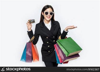 Women in black wear glasses, go shopping, carry credit cards, and lots of bags.