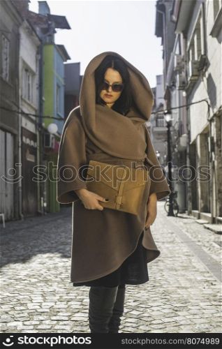 Women in brown jacket. Day light