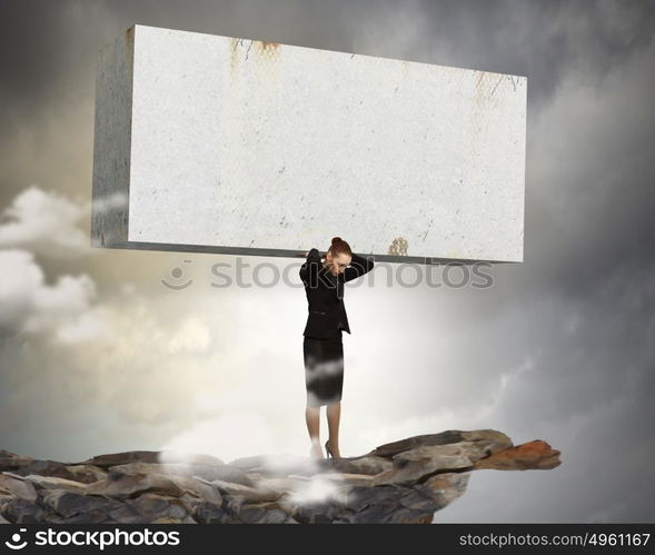 Women in business. Image of businesswoman holding stone on her shoulders