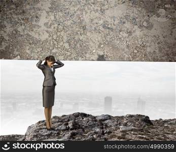 Women in business. Image of businesswoman holding stone on her shoulders