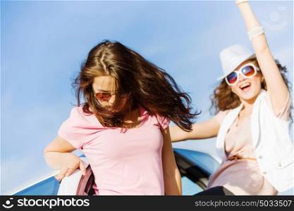 Women in car. Young pretty women leaning out of car window