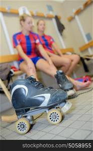 Women in changing room, roller boot in foreground