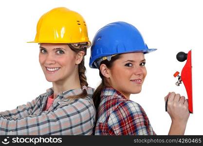 Women in hard hats with a carpenter&acute;s plane