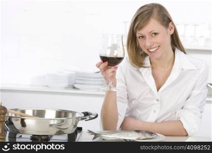 Women in kitchen with glass of wine