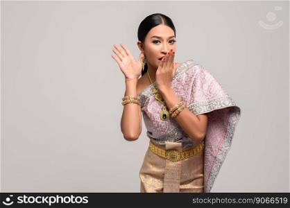 women is wearing Thai clothes and hand-made to cover her mouth.