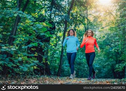 Women Jogging Outdoors in a Public Park. Autumn, Fall.. Women Jogging Outdoors in a Public Park.