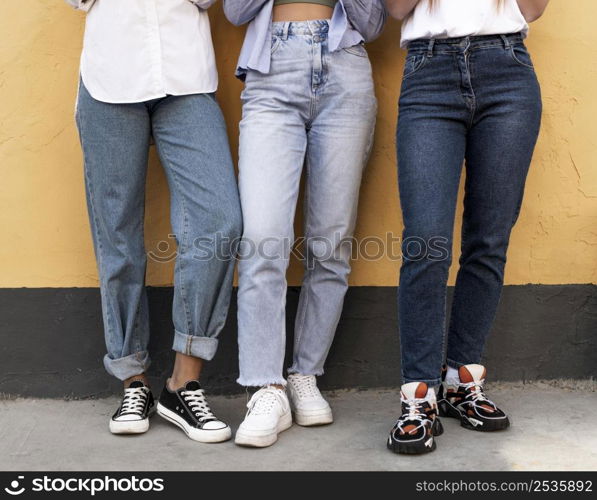 women legs front yellow wall