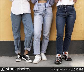 women legs front yellow wall