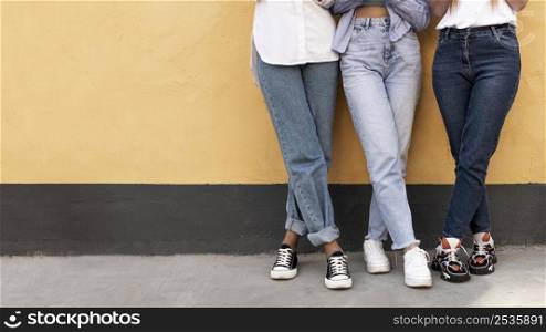 women legs front yellow wall with copy space